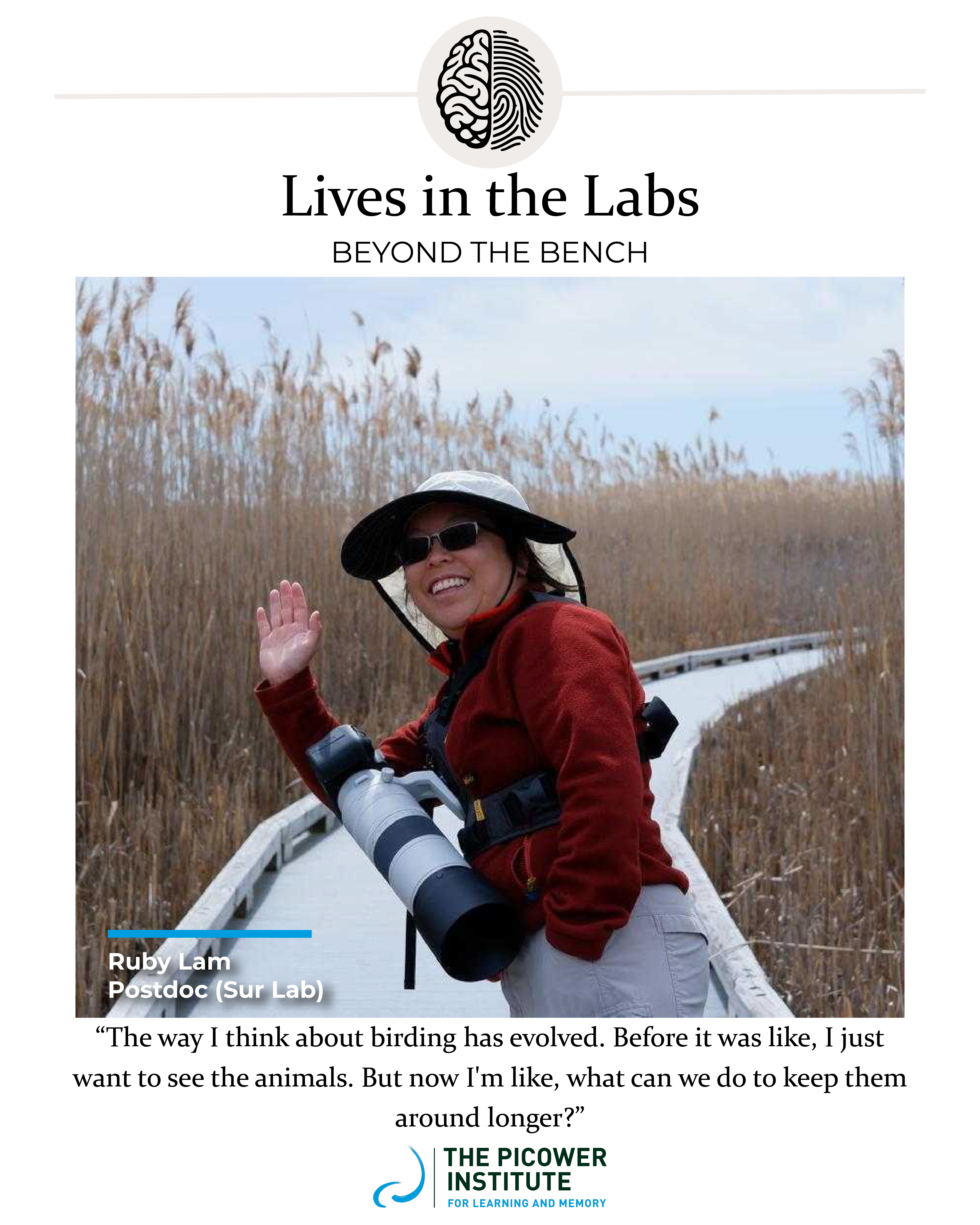 Ruby Lam waves to the camera as she stands on a boardwalk through tall grass and holds a camera with a large telephoto lens