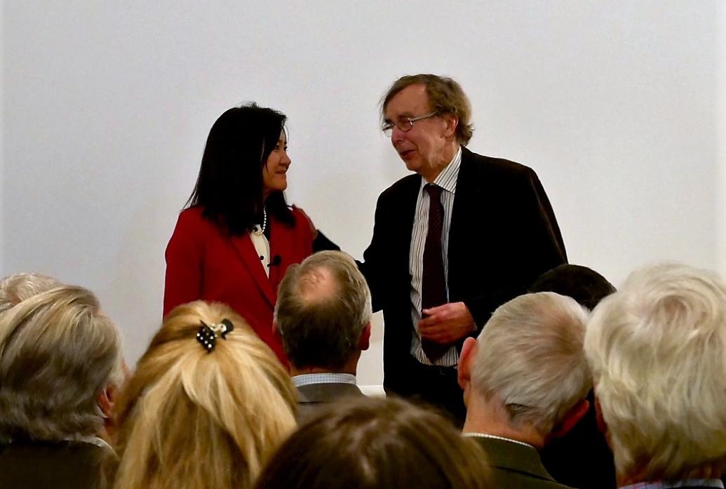 Li-Huei Tsai and Hans Wigzell talk at the front of a lecture room as an audience watches