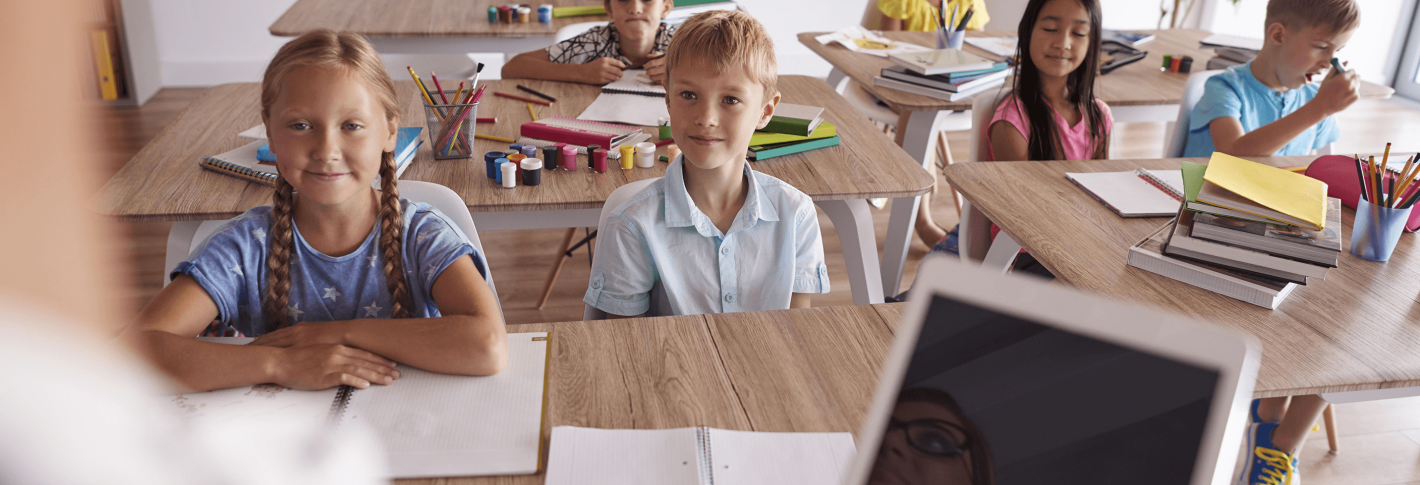 Children in a classroom listen to their teacher