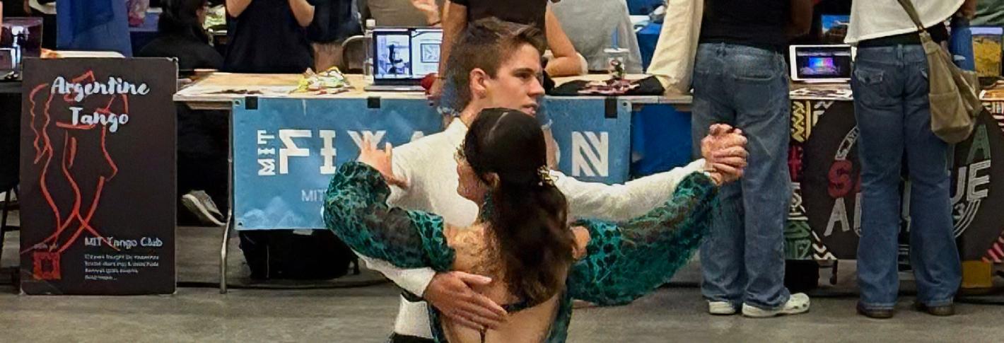 Brian Goodell dances across a floor with Kendall Nakai