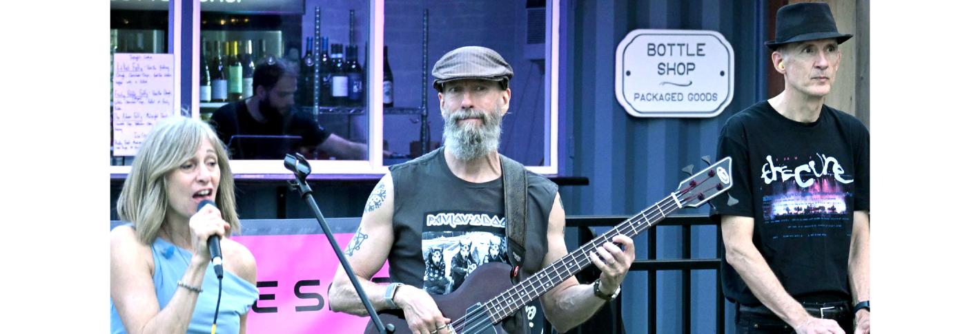 Earl Miller stands among bandmates as he plays his bass guitar