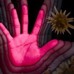 A hand with motion blur around it to suggest it's waving is surrounded by large spiky virus particles