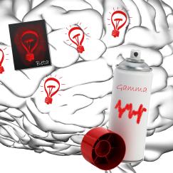 A black and white brain shown in profile is decorated with red light bulbs on its surface. In one spot, a stencil for making the light bulbs, labeled "beta," is present. Nearby is a can of red spray paint labeled "gamma" with a little wave on it.