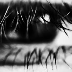 A black and white close up photo of an eye