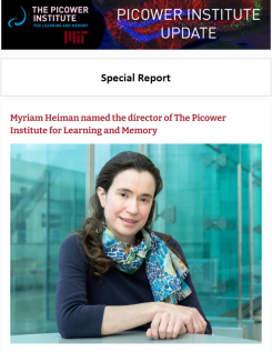e-news screenshot features Myriam Heiman seated in a 6th floor room of MIT's Building 46 with huge bluish glass windows behind her.